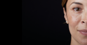 Half of a woman's face on a black background